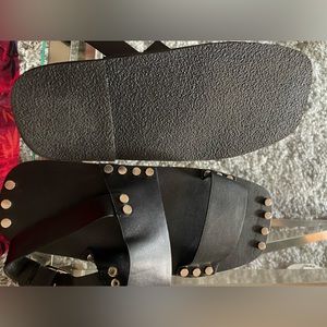 handcrafted fashion-forward white leather sandal with silver tone stud detail.